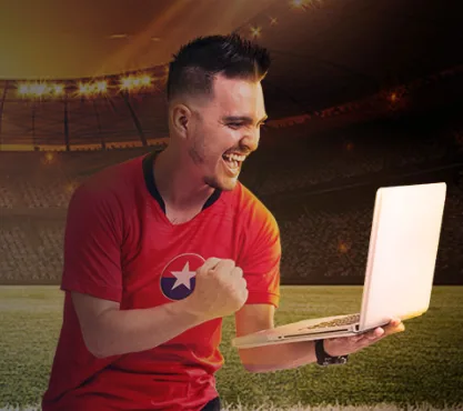 Gráfica promocional del blog de rojabet: un hincha celebra frente a un computador portátil en un estadio.
